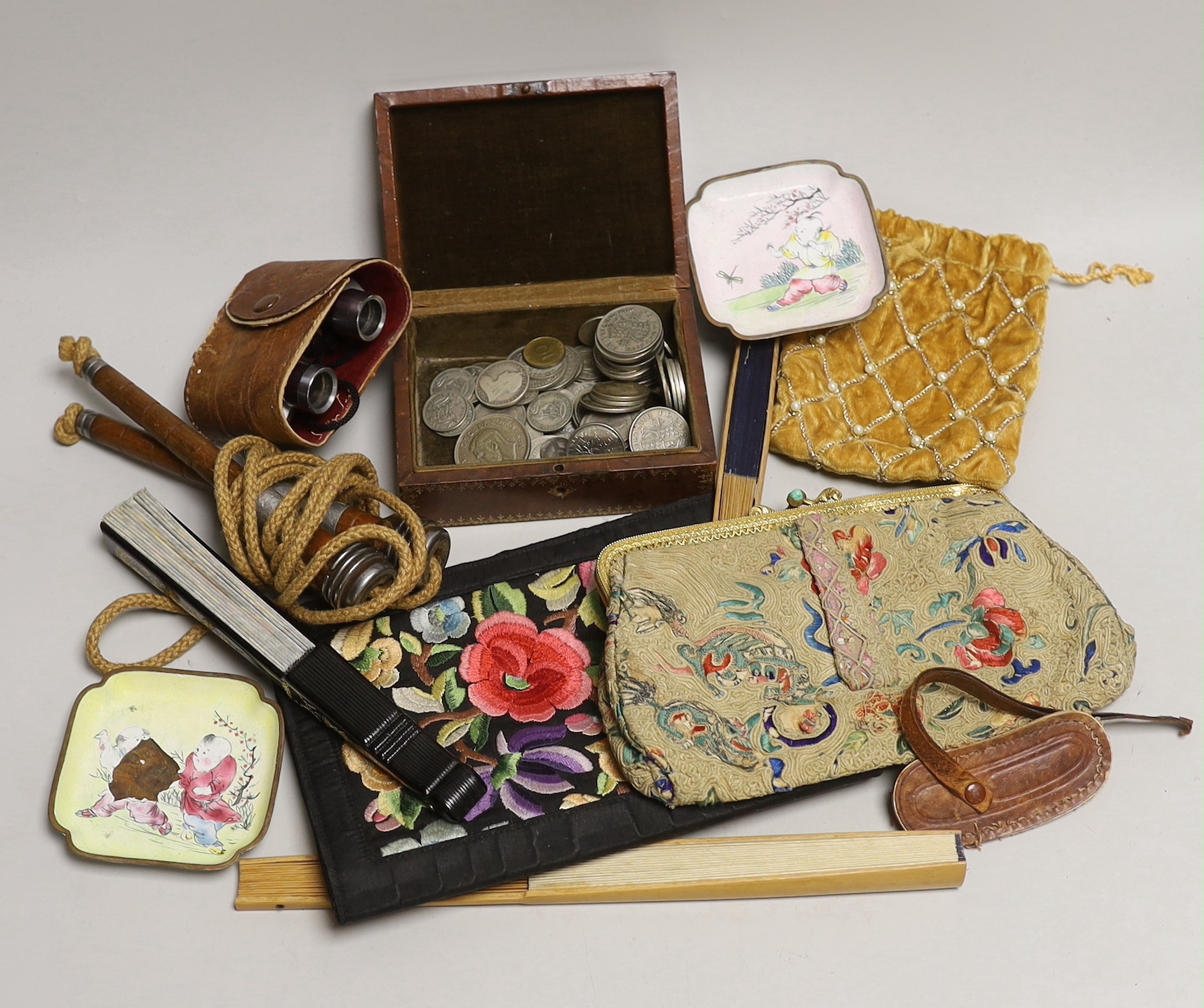 A group of mixed collectables to include a group of various coins such as crowns, half crowns and shillings, opera glasses, a skipping rope, Chinese enamelled pin dishes, fans etc.